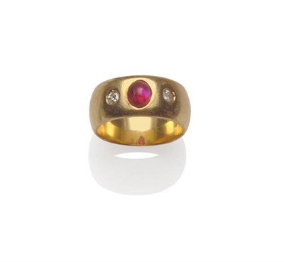 Lot 183 - A Three Stone Ring, a cabochon ruby within two round brilliant cut diamonds, drill set into a broad