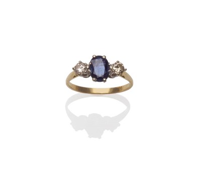 Lot 184 - A Sapphire and Diamond Three Stone Ring, an oval mixed cut sapphire between two round brilliant cut