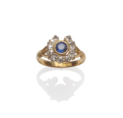 Lot 186 - A Sapphire and Diamond Horseshoe Ring, the round brilliant cut sapphire in a yellow rubbed over...