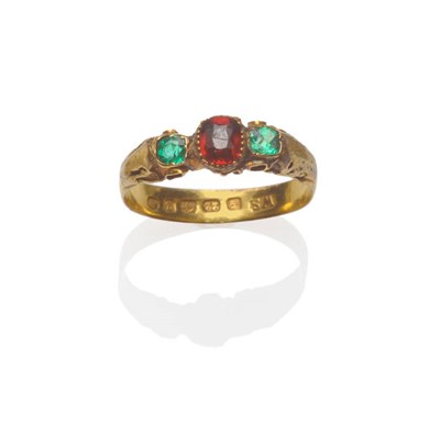 Lot 210 - A 22 Carat Gold Garnet and Emerald Three Stone Ring, a central cushion cut garnet flanked by an...