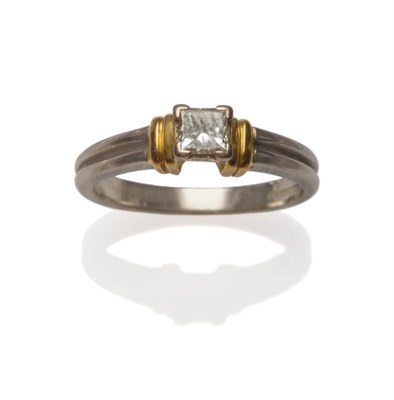 Lot 8 - An 18 Carat Gold Diamond Solitaire Ring, of white double band form, a princess cut diamond claw...
