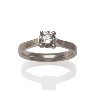 Lot 9 - A Platinum Diamond Solitaire Ring, the round brilliant cut diamond in a four claw setting, to a...