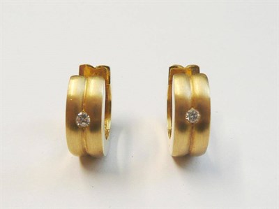 Lot 16 - A Pair of 18 Carat Gold Cuff Earrings, the brushed finish hinged form with a round brilliant...