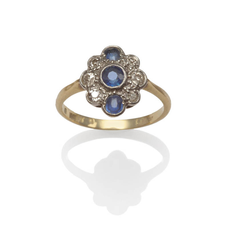 Lot 28 - A Sapphire and Diamond Cluster Ring, circa 1930, the three sapphires set with six old cut diamonds