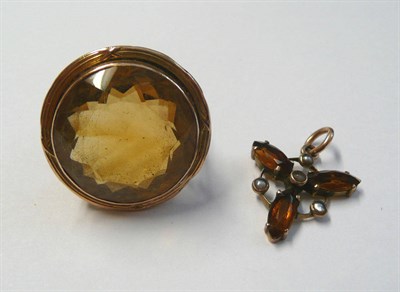 Lot 33 - A Citrine Ring, the round faceted citrine in a lined frame, on a forked shoulder plain polished...