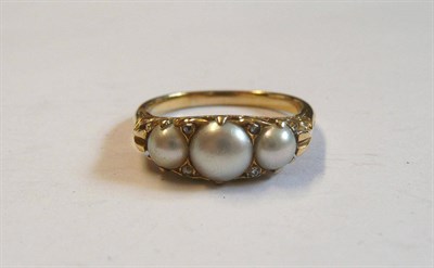 Lot 40 - A Victorian Pearl and Diamond Ring, three graduated half pearls spaced by pairs of rose cut...