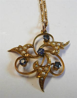 Lot 42 - An Early 20th Century Sapphire and Seed Pearl Pendant on Chain, the openwork swirl form set...