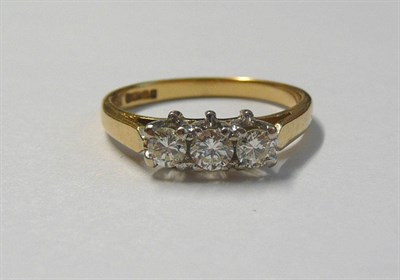 Lot 43 - An 18 Carat Gold Diamond Three Stone Ring, the round brilliant cut diamonds in white claw settings