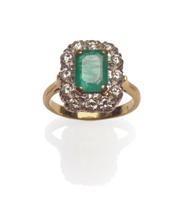 Lot 54 - An Emerald and Diamond Cluster Ring, the step cut emerald in a yellow four claw setting, within...