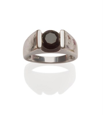 Lot 59 - A 9 Carat White Gold Diamond Solitaire Ring, a round brilliant cut black diamond in a tension...