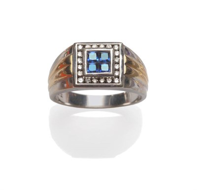 Lot 60 - A Sapphire and Diamond Ring, four square cut sapphires in a white rubbed over setting, within a...