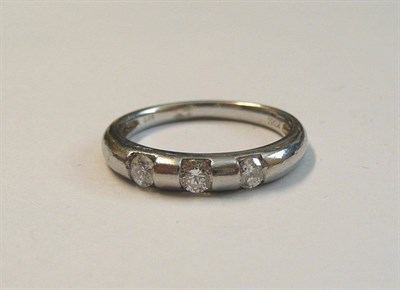 Lot 63 - A Platinum Diamond Set Band Ring, the plain polished band with three round brilliant cut...