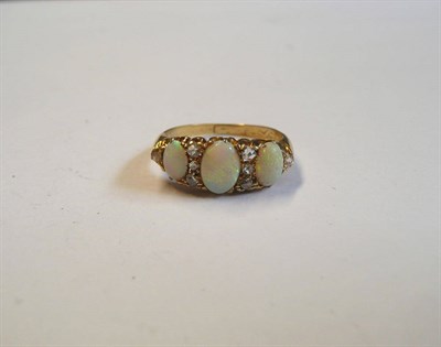 Lot 73 - A Victorian Opal and Diamond Ring, three graduated oval cabochon opals spaced by rose cut diamonds