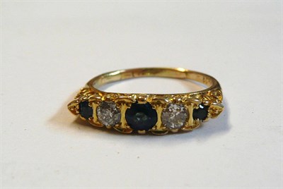 Lot 74 - A Sapphire and Diamond Ring, three graduated sapphires alternate with two old cut diamonds, in...