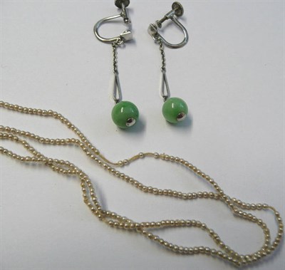 Lot 90 - A Pair of Jade Drop Earrings, a white bevelled square suspends chain links to a teardrop panel...