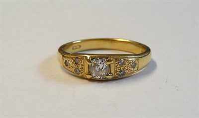 Lot 94 - An 18 Carat Gold Diamond Ring, an old cut diamond centrally, within textured shoulders set with...
