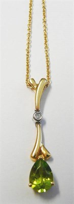 Lot 101 - An 18 Carat Gold Peridot and Diamond Pendant, a branch like form with a diamond set centrally and a
