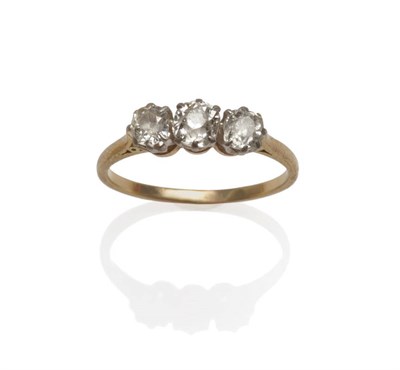 Lot 106 - A Diamond Three Stone Ring, the graduated old cut diamonds in white claw settings, to a yellow...