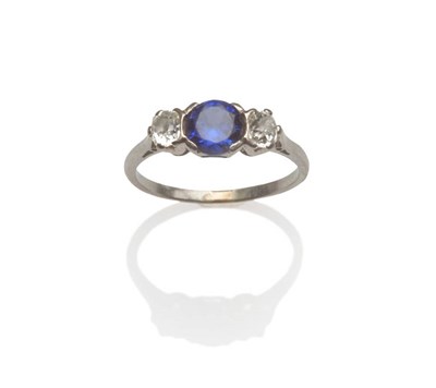 Lot 126 - A Sapphire and Diamond Three Stone Ring, the round brilliant cut sapphire set between two old...