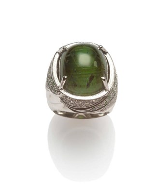 Lot 128 - An 18 Carat White Gold Cat's Eye Tourmaline Ring, the large cabochon tourmaline in a four claw...