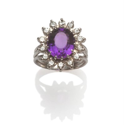 Lot 130 - An Amethyst and Diamond Cluster Ring, an oval mixed cut amethyst within a border of round brilliant