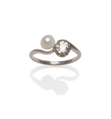 Lot 150 - A Diamond and Cultured Pearl Two Stone Twist Ring, the old cut diamond and the cultured pearl...