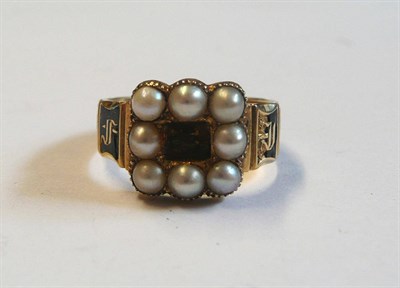 Lot 159 - An 18 Carat Gold Mourning Ring, the centre panel within a border of half pearls, to a scalloped...