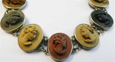 Lot 165 - A Lava Cameo Bracelet, the oval lava stones depicting portraits, in shades of brown, red and black