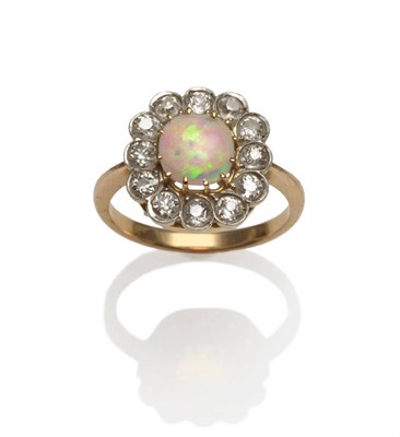 Lot 172 - An Early 20th Century Opal and Diamond Cluster Ring, the cushion shaped cabochon opal in a...