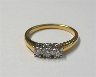 Lot 194 - An 18 Carat Gold Diamond Three Stone Ring, the round brilliant cut diamonds in white claw settings