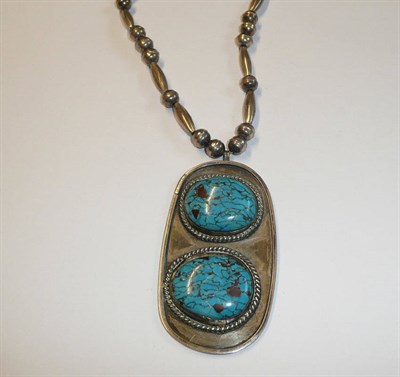 Lot 198 - An American-Indian Necklace, white metal bead and barrel links suspend a large pendant of...