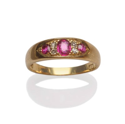 Lot 205 - An 18 Carat Gold Ruby and Diamond Ring, graduated oval cut rubies alternate with pairs of...