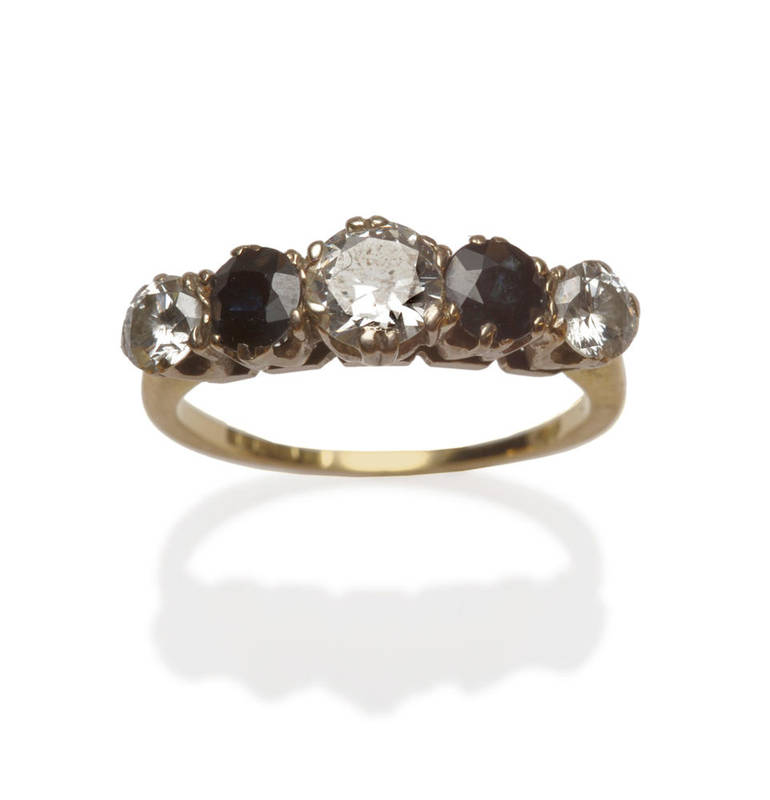 Lot 207 - A 14 Carat Gold Diamond and Sapphire Five Stone Ring, three graduated round brilliant cut...