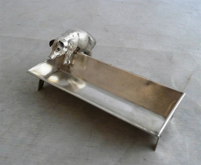 Lot 268 - A George V Novelty Silver Pin Tray, Birmingham 1907, modelled as a pig eating from a trough,...