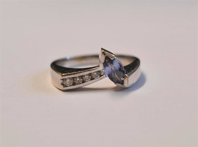 Lot 1015 - A 9 Carat White Gold Tanzanite and Diamond Ring, with a marquise cut tanzanite and graduated...