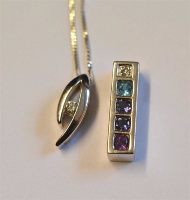 Lot 1016 - A 9 Carat White Gold Diamond and Amethyst Pendant, the oblong mount set with a row of multi...