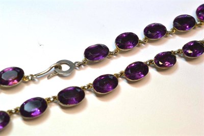 Lot 1020 - A Purple Paste Necklace, the oval stones in white collet settings, length 39.5cm