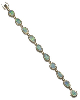 Lot 1028 - An Opal Triplet and Diamond Bracelet, irregular shaped opal triplets in yellow rubbed over settings