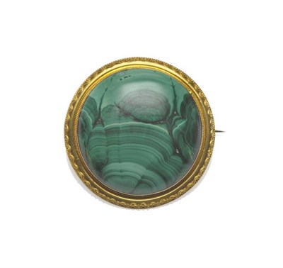 Lot 1046 - A Malachite Brooch, the large circular cabochon malachite within a rope twist decorated frame,...