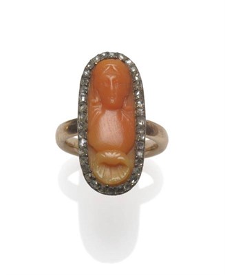 Lot 1048 - A Late Victorian Coral and Diamond Ring, the lozenge shaped coral carved with a portrait and shell