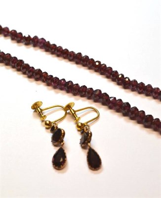 Lot 1051 - A Pair of Garnet Drop Earrings, the foil backed stones in closed back claw settings, with...