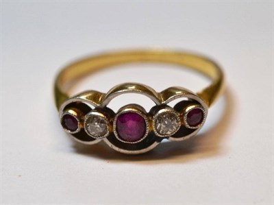 Lot 1053 - A Ruby and Diamond Five Stone Ring, three graduated round cut rubies alternate with old cut...