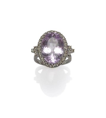 Lot 1056 - An 18 Carat White Gold Kunzite and Diamond Ring, the oval cut kunzite within a border of round...