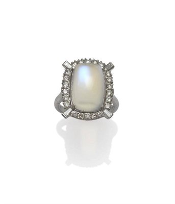 Lot 1058 - A 14 Carat White Gold Moonstone and Diamond Cluster Ring, the oblong cabochon moonstone within...