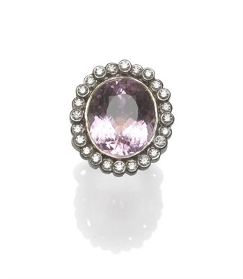 Lot 1059 - An 18 Carat White Gold Kunzite and Diamond Cluster Ring, the oval cut bezel set kunzite within...