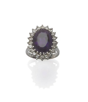 Lot 1060 - An Amethyst and Diamond Cluster Ring, an oval mixed cut amethyst within a border of round brilliant