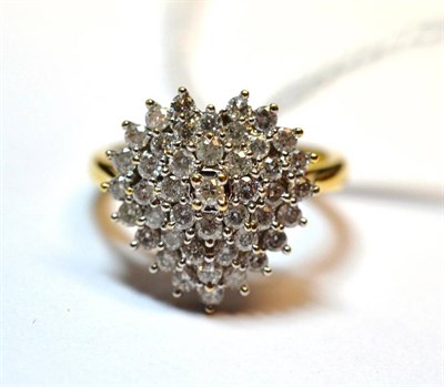 Lot 1082 - An 18 Carat Gold Diamond Cluster Ring, the round brilliant cut diamonds arranged in a heart...