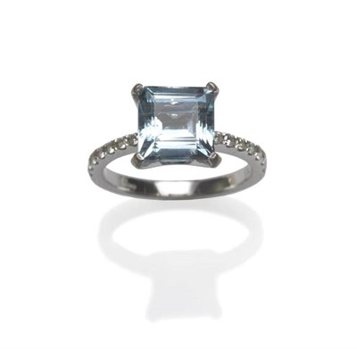 Lot 1096 - An 18 Carat White Gold Aquamarine and Diamond Ring, the square step cut aquamarine in a white...