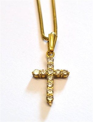 Lot 1100 - A Diamond Cross on a Chain, the cross with round brilliant cut diamonds in yellow claw settings, on