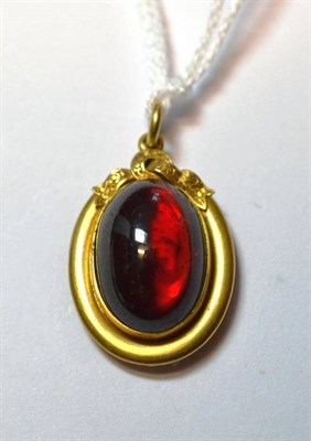 Lot 1102 - A Late Victorian Garnet Pendant, an oval carbuncle garnet within a plain polished frame, with a...